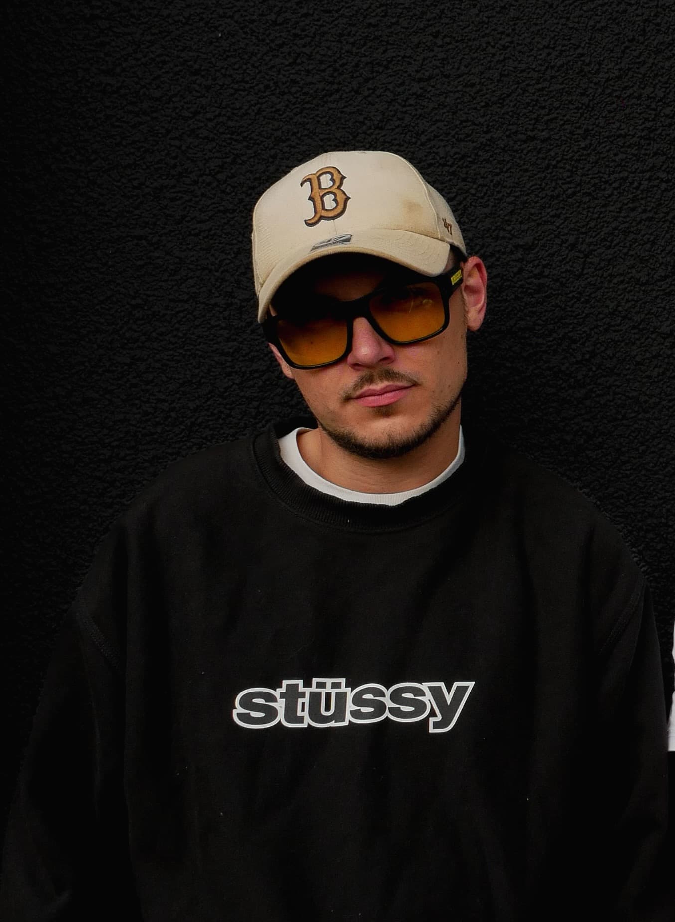 Kenny headshot wearing cap and shades