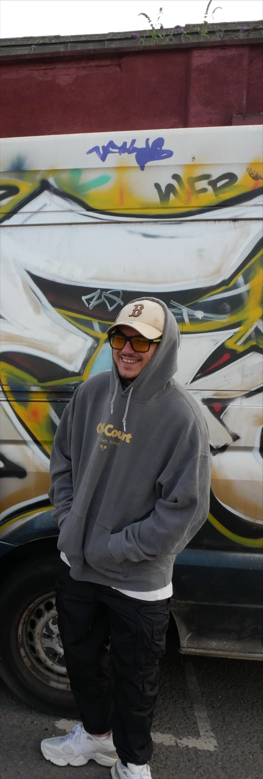 Kenny in hoodie and cap at festival