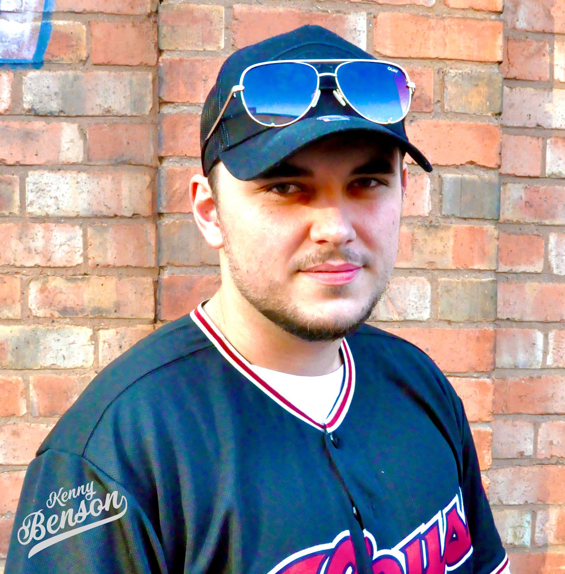 Kenny headshot wearing cap and shades